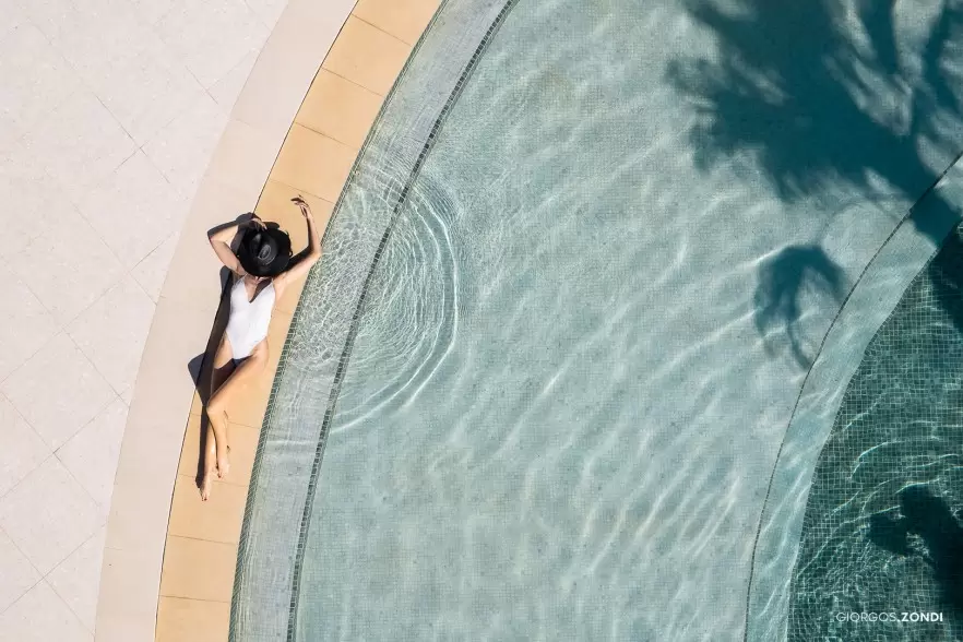 Drone lifestyle photo of the Nautilux Hotel poolside, featuring a luxurious and serene atmosphere.