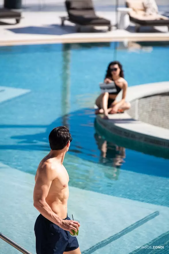 Lifestyle photo of a couple relaxing by the pool at Nautilux Hotel, showcasing a romantic and luxurious atmosphere.